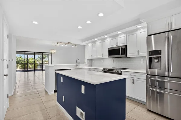 a kitchen with a sink microwave and refrigerator