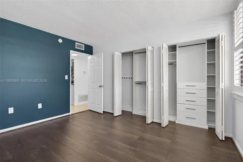 an empty room with closet and a window