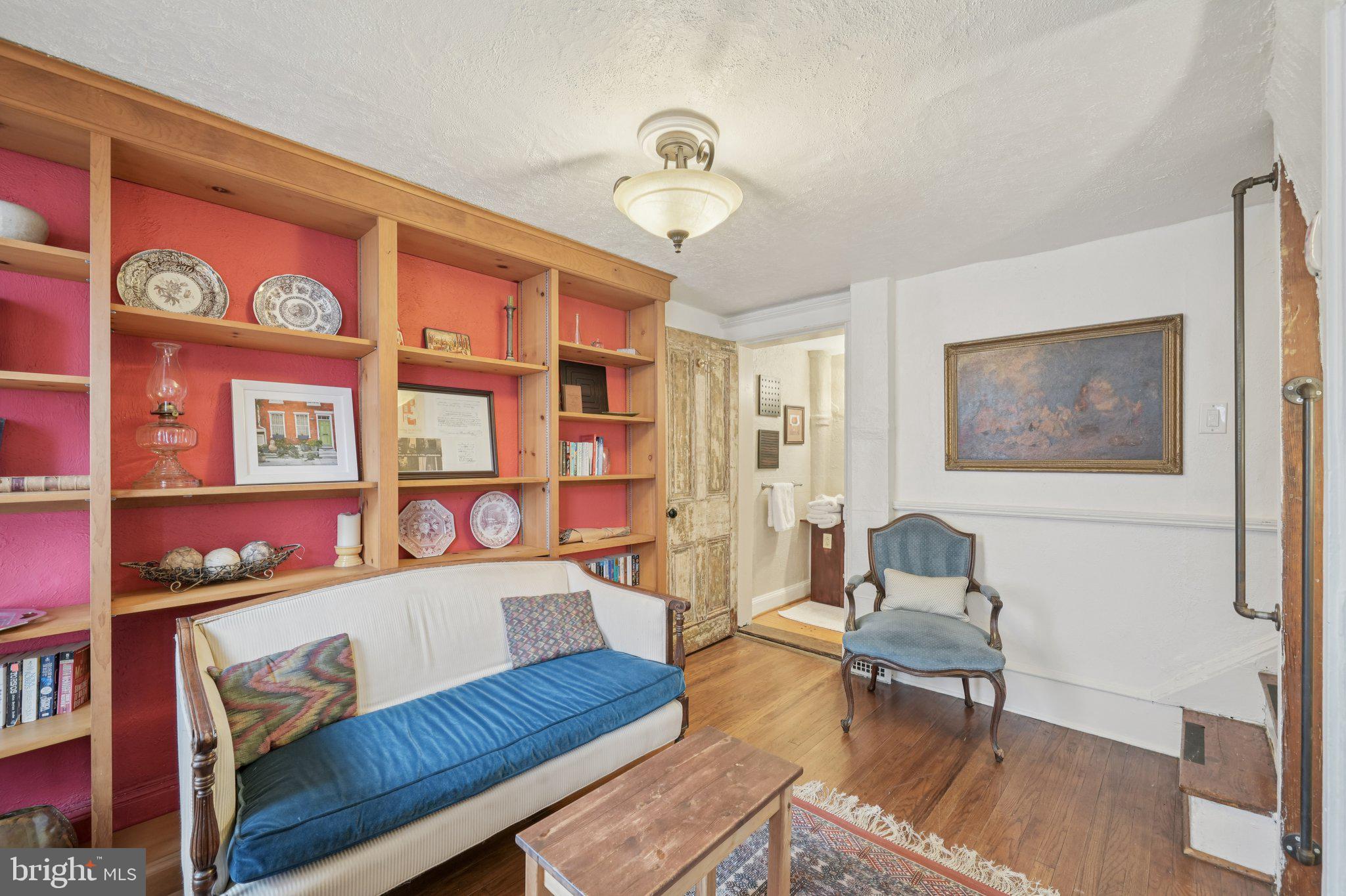 405 South 17th Street Philadelphia, PA 19146 - Photo 12 of 24 a living room with furniture a rug and a bookshelf