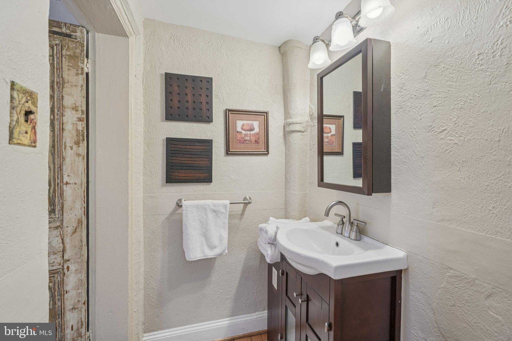 405 South 17th Street Philadelphia, PA 19146 - Photo 15 of 24 a bathroom with a sink a light fixture and a mirror