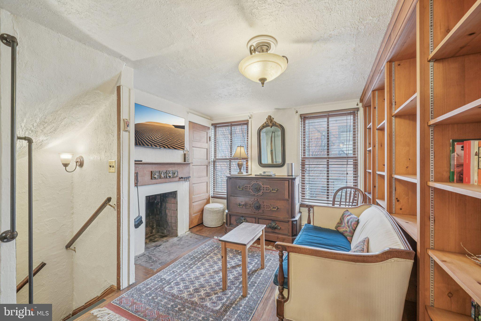 405 South 17th Street Philadelphia, PA 19146 - Photo 9 of 24 a living room with furniture a fireplace and a flat screen tv