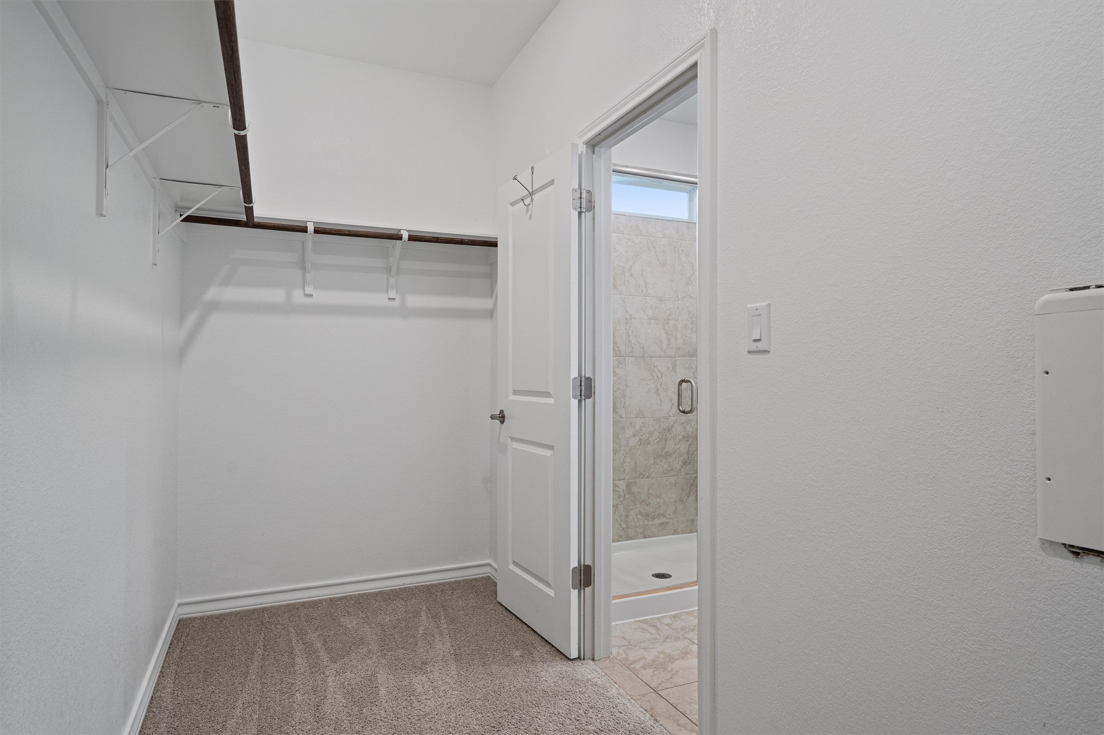 104 Stinchcomb Road Hutto, TX 78634 - Photo 20 of 40
The private primary suite offers more greenbelt views, an en suite bath with dual vanities, a walk-in shower, and a spacious walk-in closet.