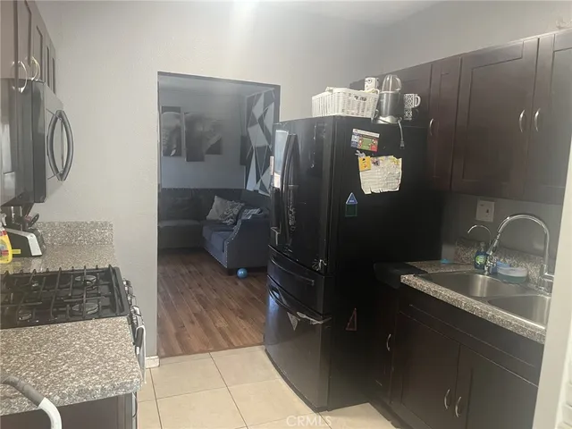 a bathroom with a granite countertop sink a mirror and shower