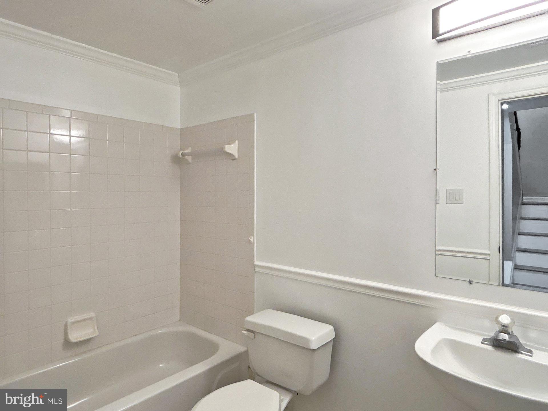 3558 Corn Stream Road Randallstown, MD 21133 - Photo 15 of 28 a bathroom with a granite countertop bathtub shower sink vanity and toilet