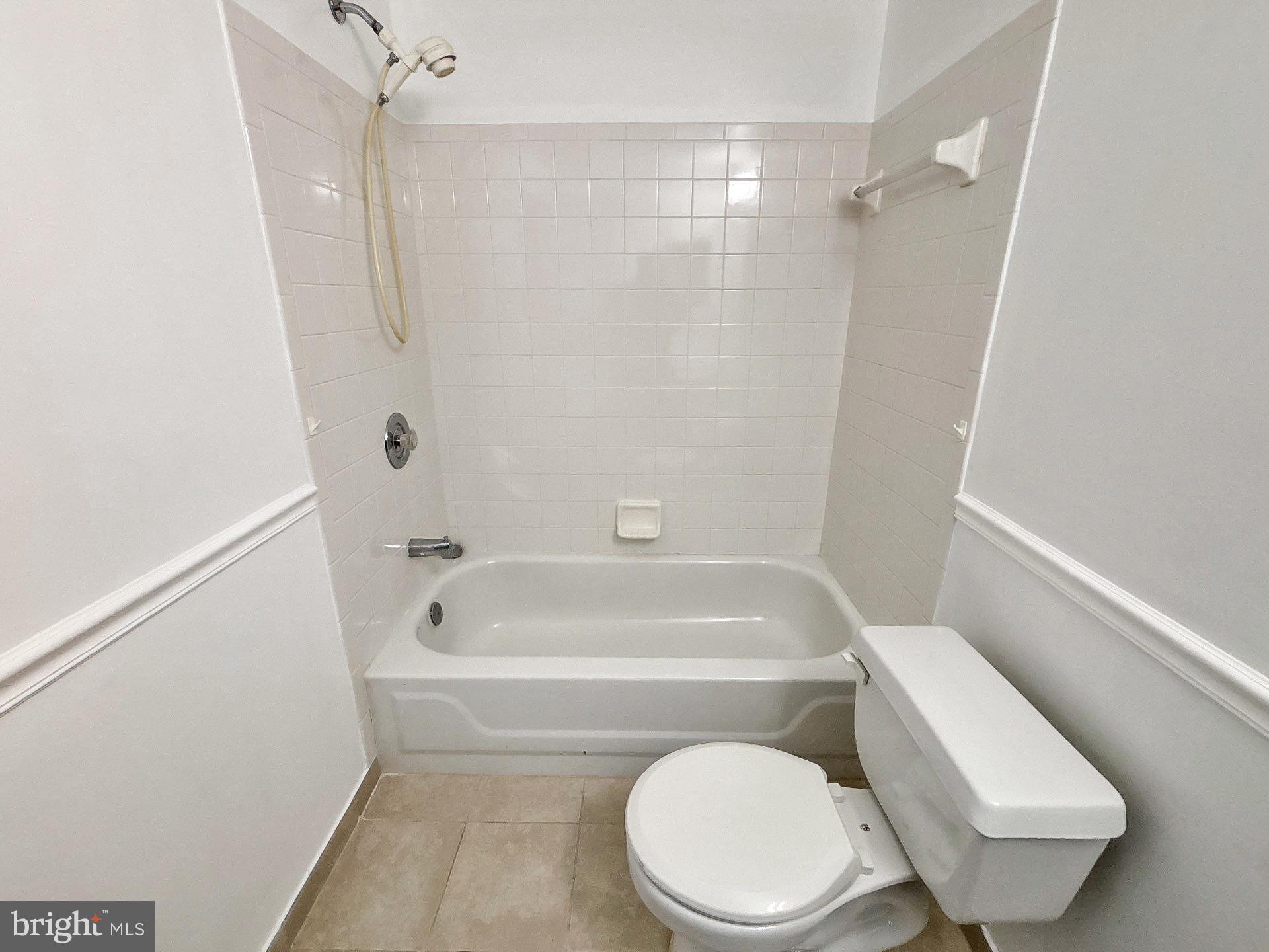 3558 Corn Stream Road Randallstown, MD 21133 - Photo 16 of 28 a white toilet and tub next to a shower