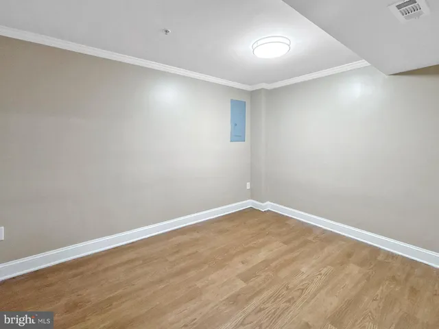 a view of an empty room with wooden floor