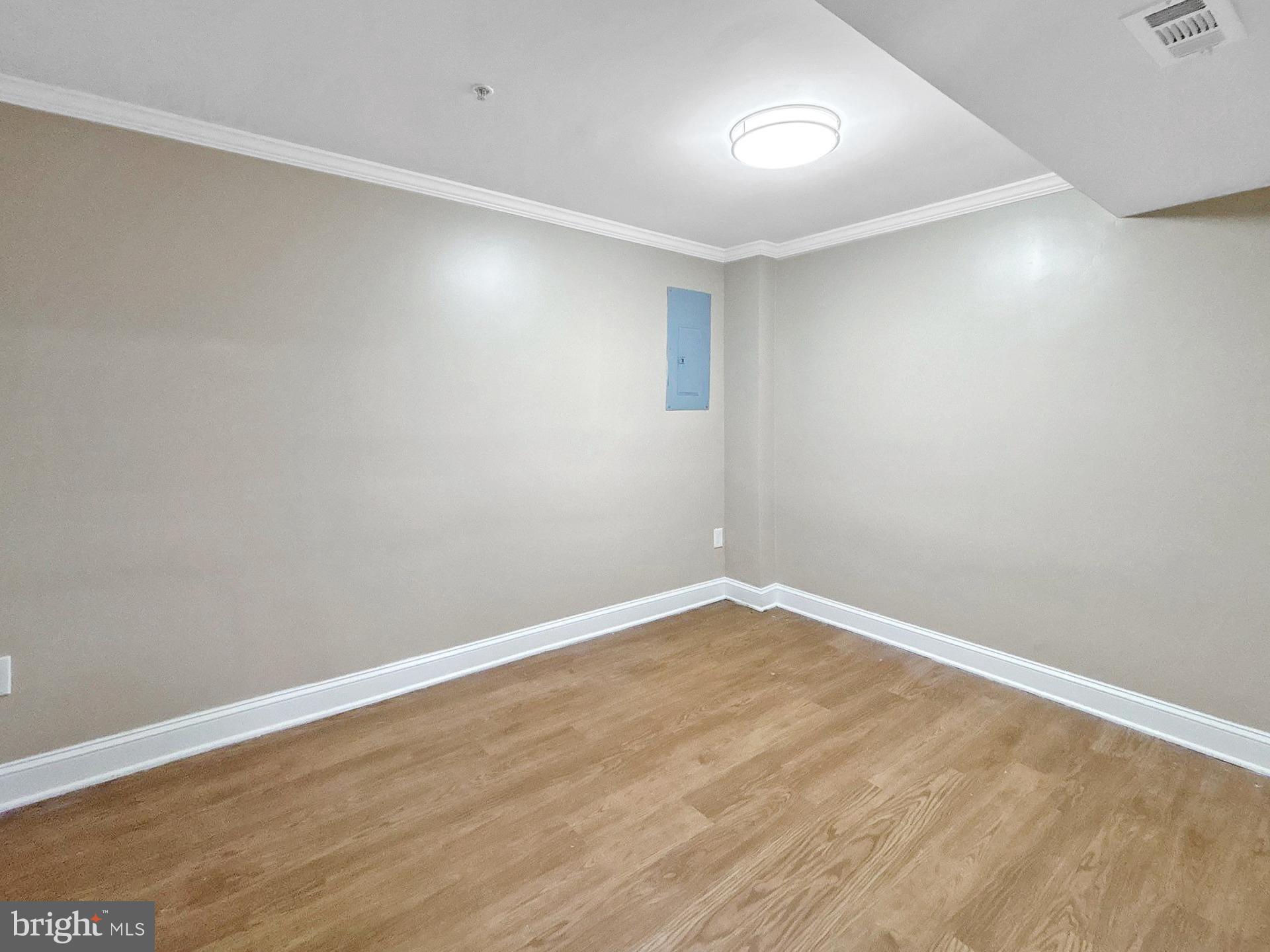 3558 Corn Stream Road Randallstown, MD 21133 - Photo 21 of 28 a view of an empty room with wooden floor