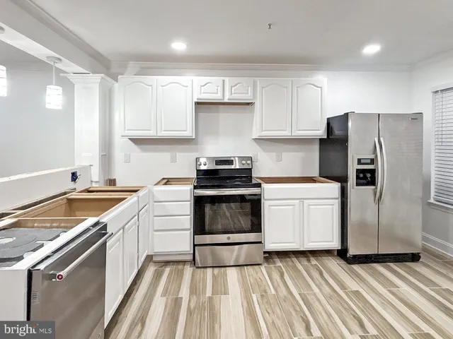 a kitchen with a stove sink and refrigerator