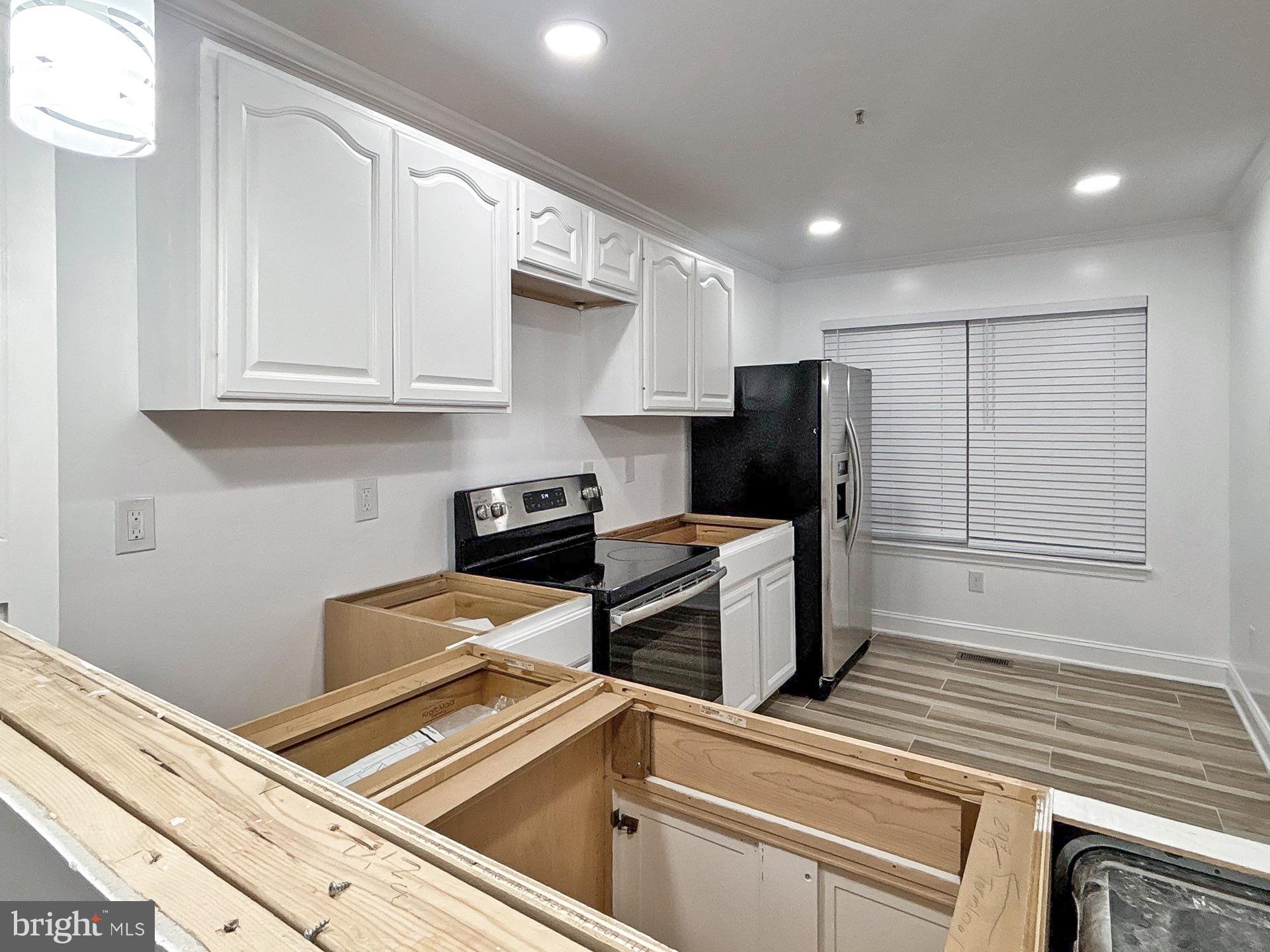 3558 Corn Stream Road Randallstown, MD 21133 - Photo 4 of 28 a kitchen with stainless steel appliances granite countertop a refrigerator and a stove top oven