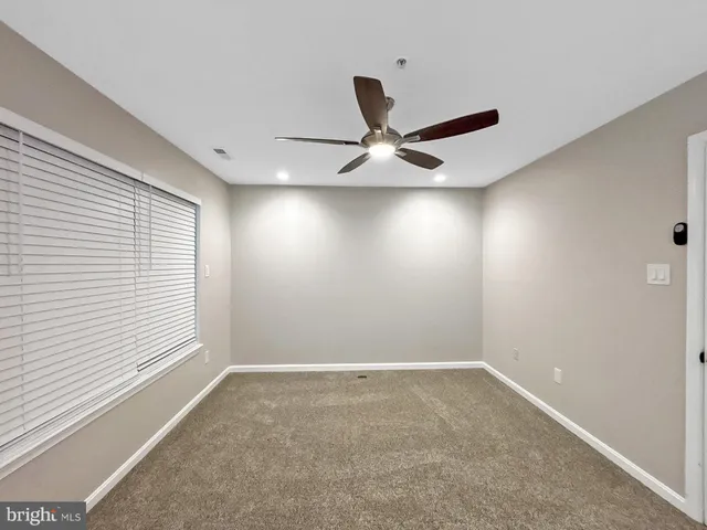 a view of room with a ceiling fan and window