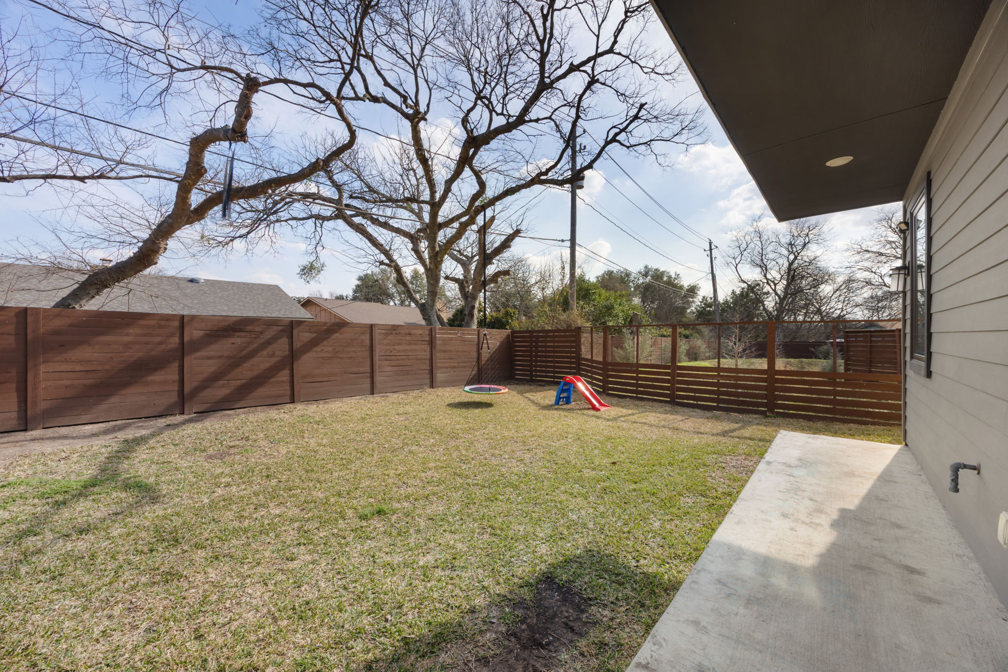 1417 Kramer Lane, Unit 14 Austin, TX 78758 - Photo 26 of 33 Fenced backyard with a patio