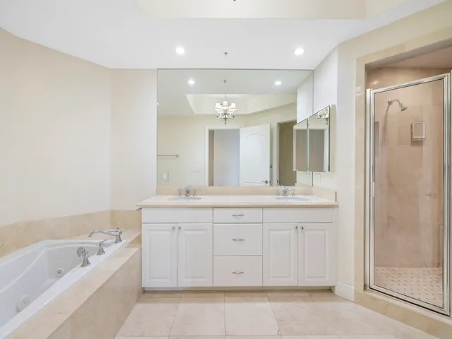 a spacious bathroom with a granite countertop sink a toilet a mirror and bathtub