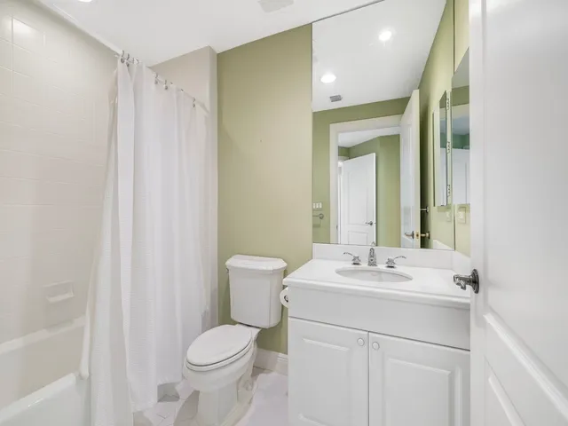 a bathroom with a sink toilet and mirror