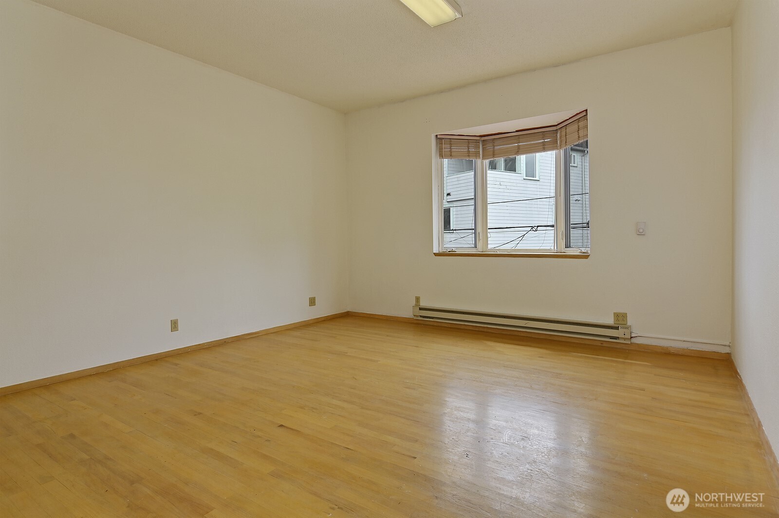 3015 Beacon Avenue South Seattle, WA 98144 - Photo 18 of 33 an empty room with a exposed radiator and a window