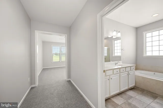 an empty room with a ceiling fan and a window