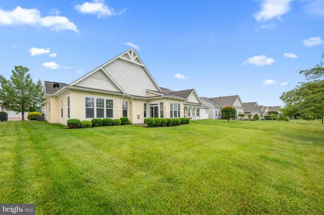 a view of a house with swimming pool and a yard