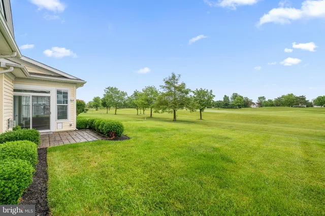a view of a patio with table and chairs