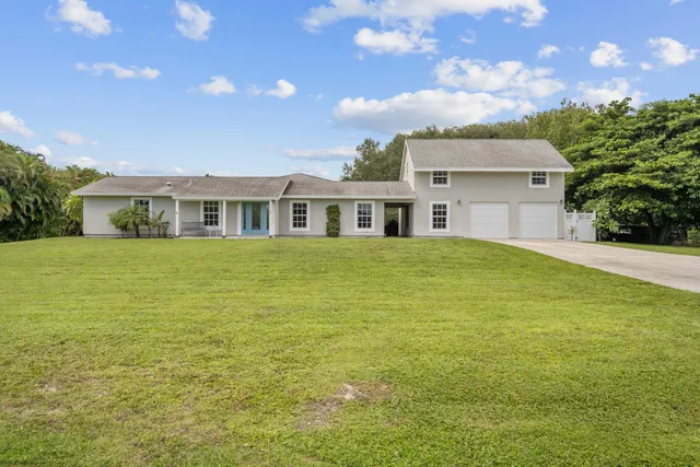 a view of a house next to a big yard