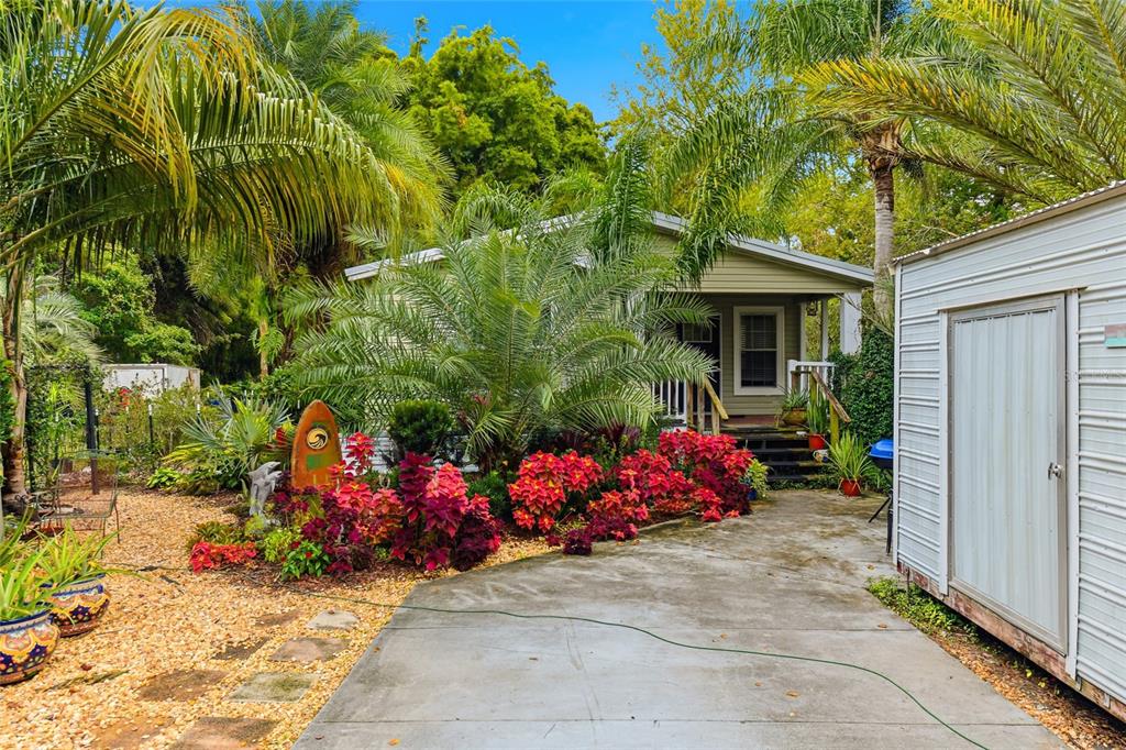 725 Cypress Road St. Augustine, FL 32086 - Photo 14 of 29 a view of a garage with a table and chairs and potted plants