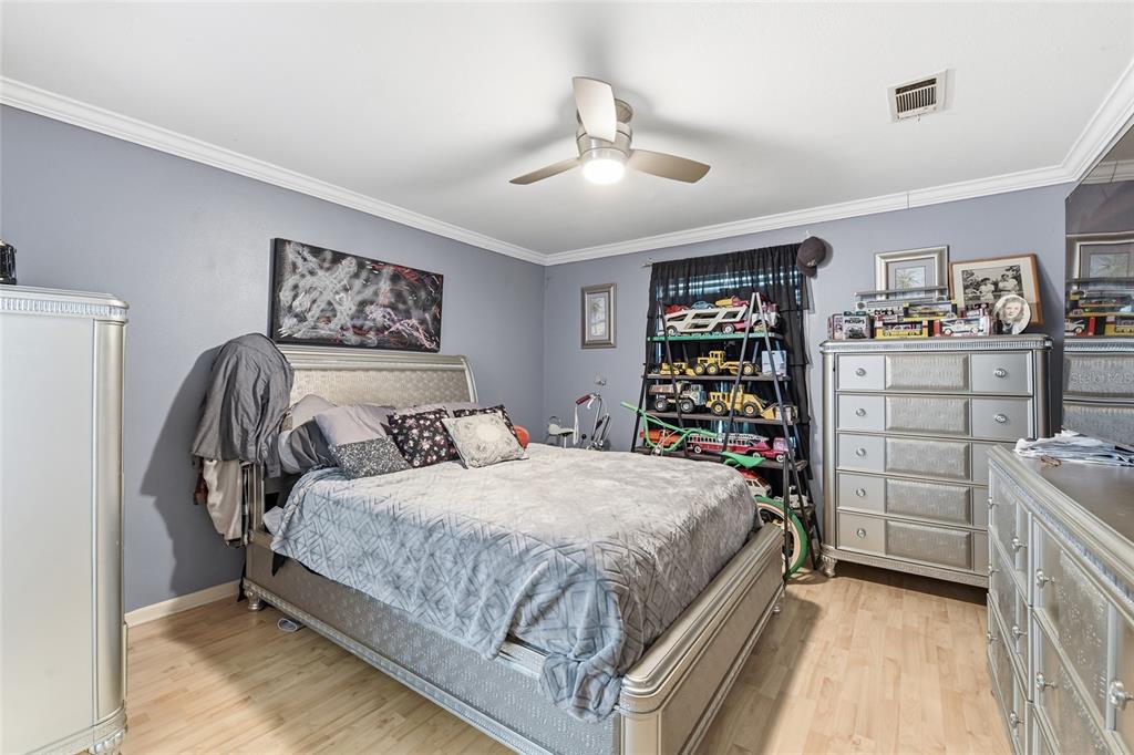 725 Cypress Road St. Augustine, FL 32086 - Photo 24 of 29 a bedroom with a bed and a cabinets