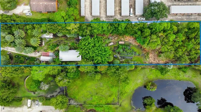 an aerial view of a house with a yard and lake view