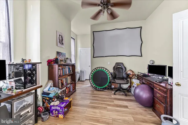 a bedroom with furniture and a workspace