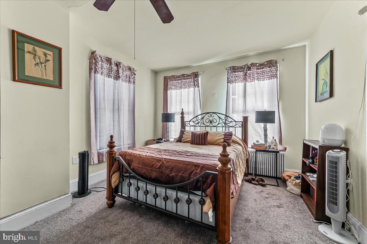 217 West Main Street Elkton, MD 21921 - Photo 19 of 37 a bedroom with a bed a table and painting on the wall