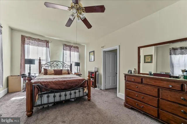 a bedroom with a bed and a dresser