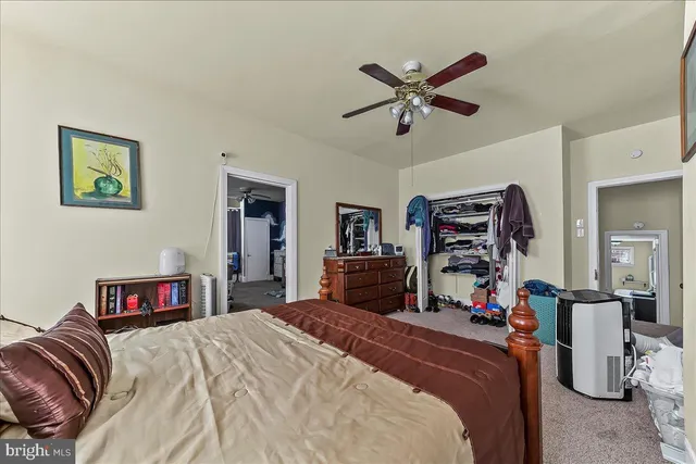 a bedroom with bed and a chandelier