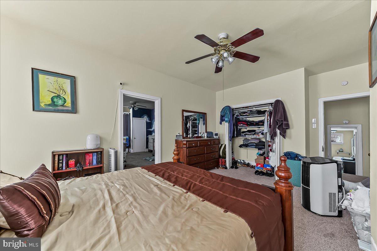 217 West Main Street Elkton, MD 21921 - Photo 21 of 37 a bedroom with bed and a chandelier