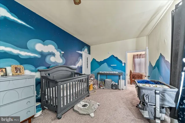 a bedroom with furniture and a baby crib