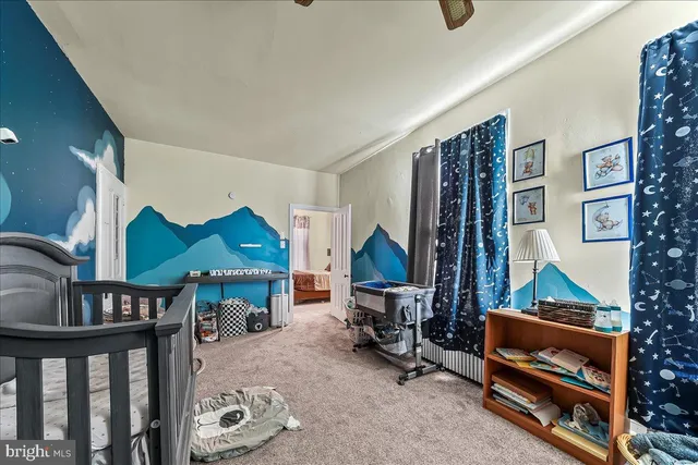 a bedroom with furniture and a lamp