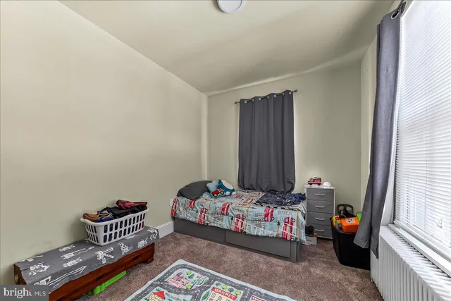 a bedroom with bed and a window