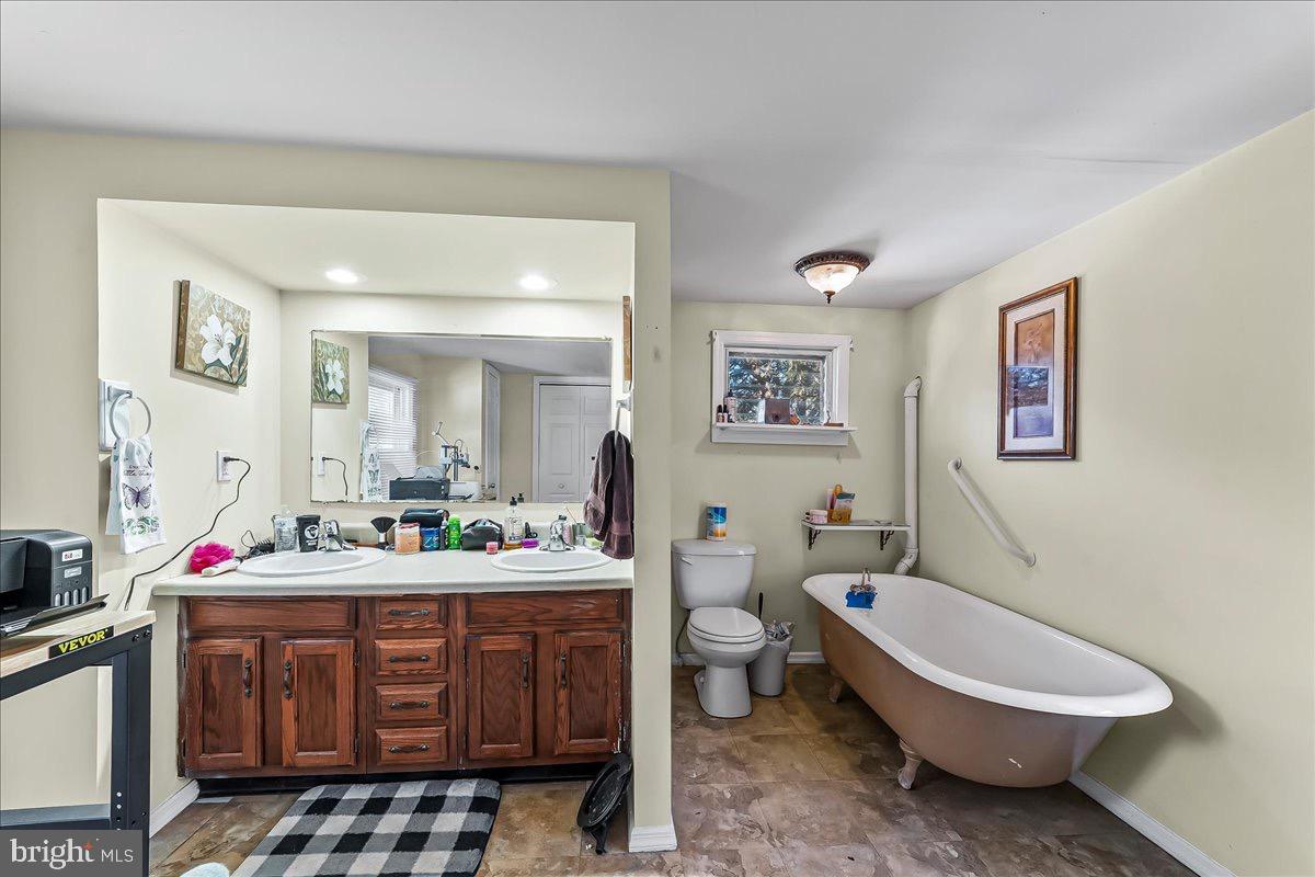 217 West Main Street Elkton, MD 21921 - Photo 28 of 37 a bathroom with a sink toilet vanity and tub