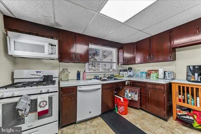 a kitchen with stainless steel appliances granite countertop a stove sink and cabinets