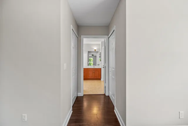 a view of a hallway with wooden floor