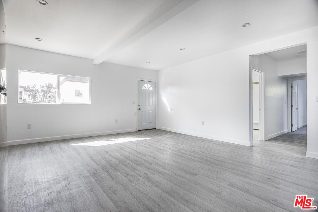 1324 Toberman Street, Unit 1/4 Los Angeles, CA 90015 - Photo 2 of 12 an empty room with wooden floor and windows