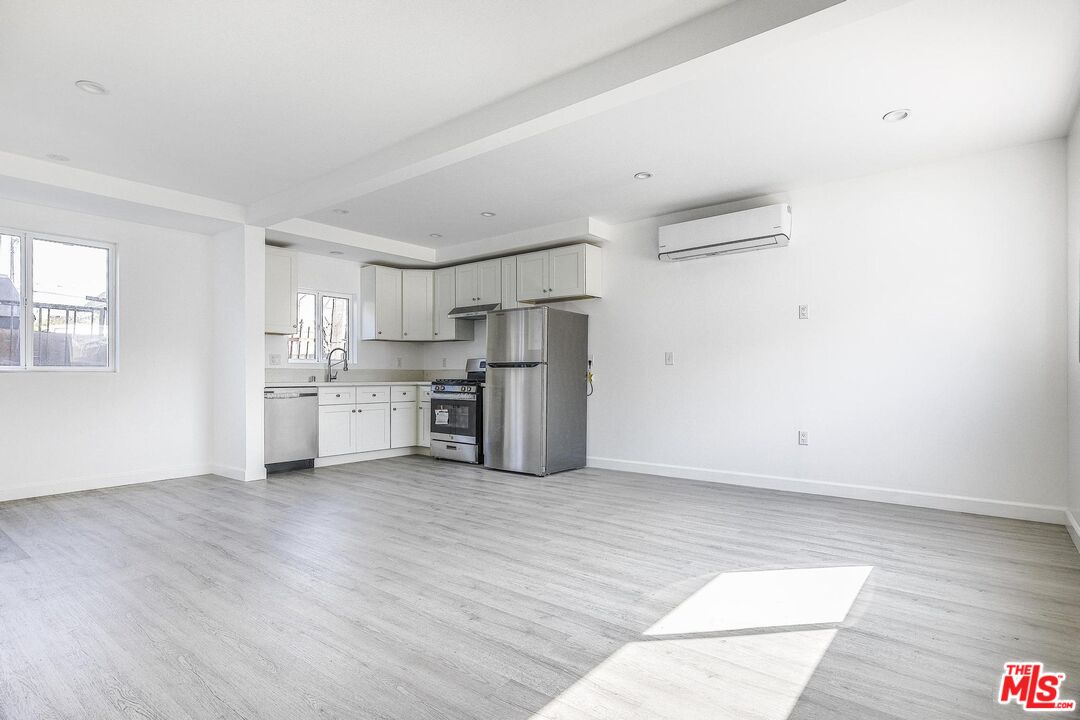 1324 Toberman Street, Unit 1/4 Los Angeles, CA 90015 - Photo 3 of 12 a view of kitchen with wooden floor and electronic appliances