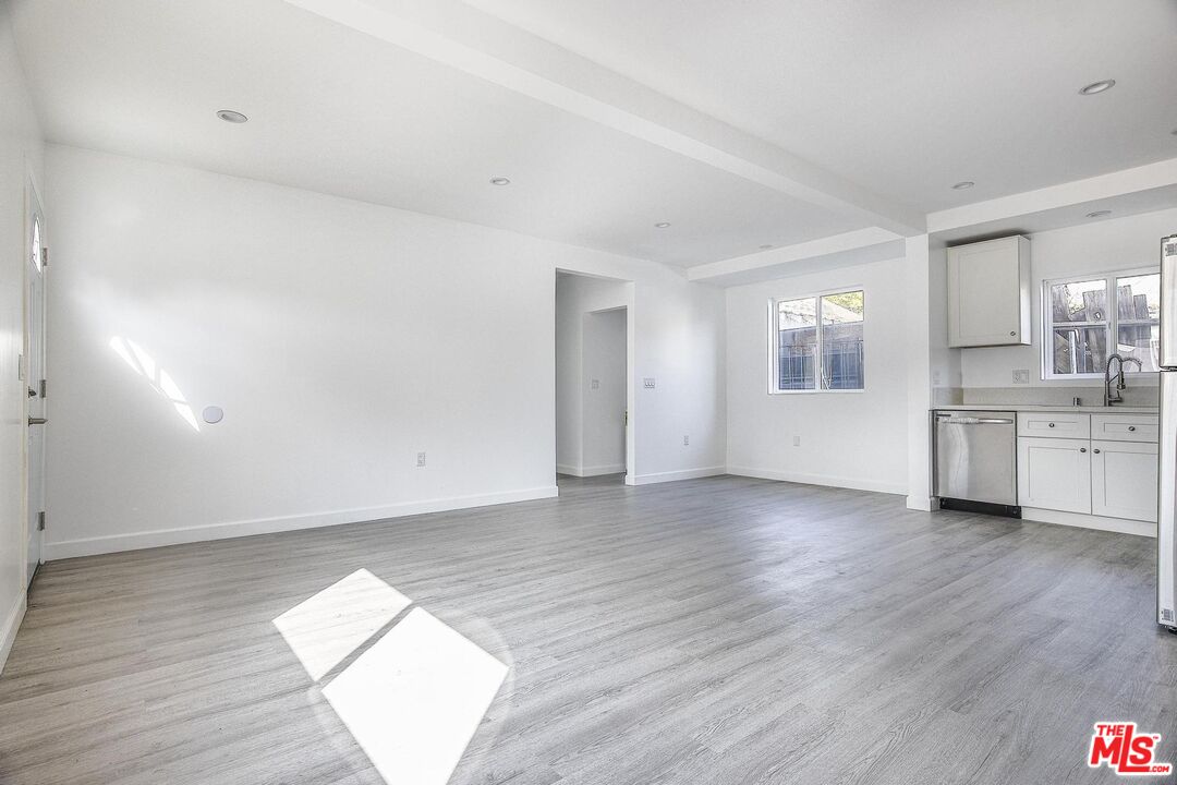 1324 Toberman Street, Unit 1/4 Los Angeles, CA 90015 - Photo 4 of 12 an empty room with wooden floor and windows