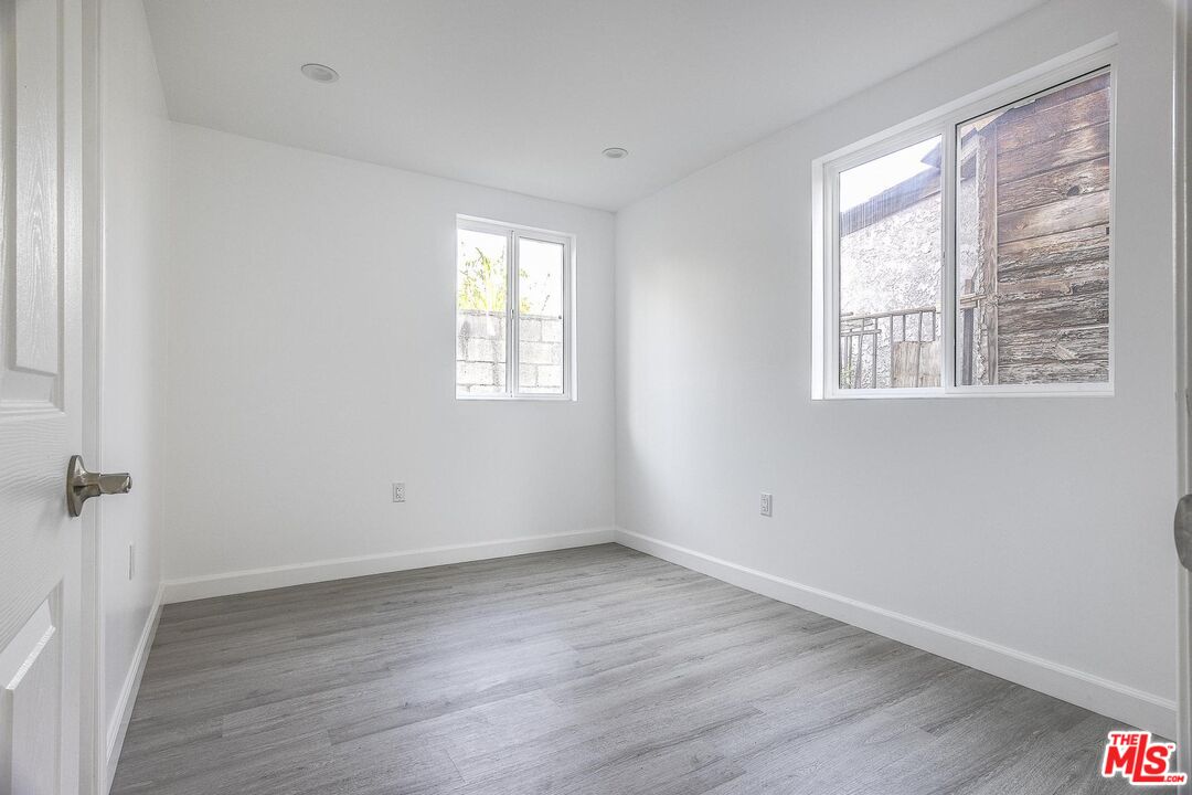 1324 Toberman Street, Unit 1/4 Los Angeles, CA 90015 - Photo 6 of 12 a view of an empty room with wooden floor and a window
