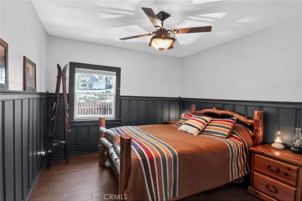 2775 View Running Springs, CA 92382 - Photo 18 of 30 a bedroom with a bed and a chandelier