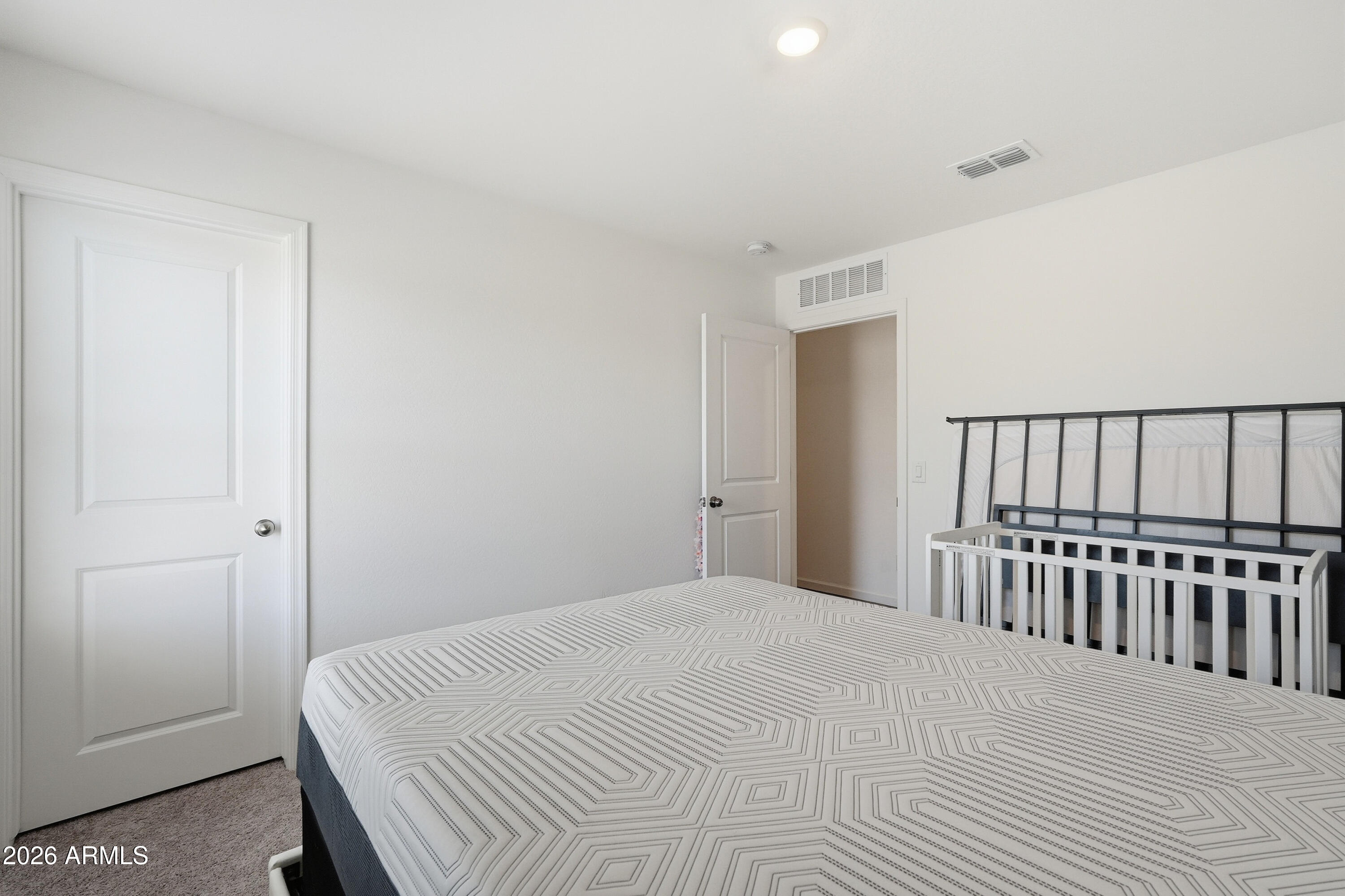 15610 South Moon Valley Road Arizona City, AZ 85123 - Photo 22 of 36 a bedroom with a bed and chair