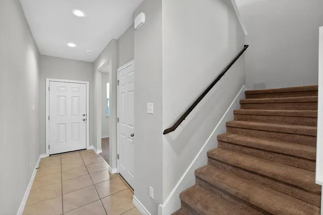 a view of entryway with wooden floor and stairs