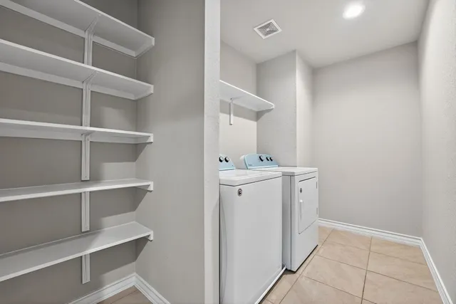 a utility room with cabinets washer and dryer