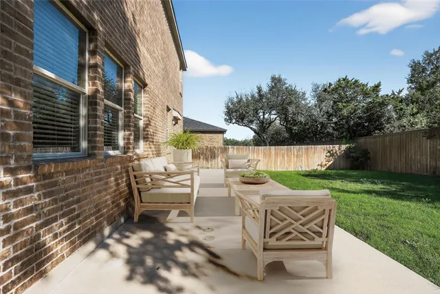 a view of backyard with outdoor seating ad green space