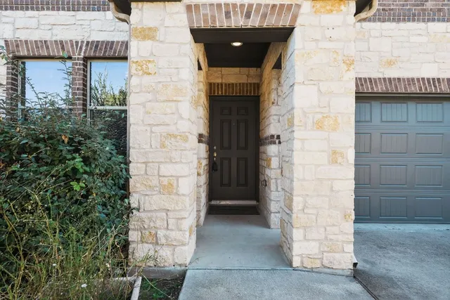 an entrance to house with yard