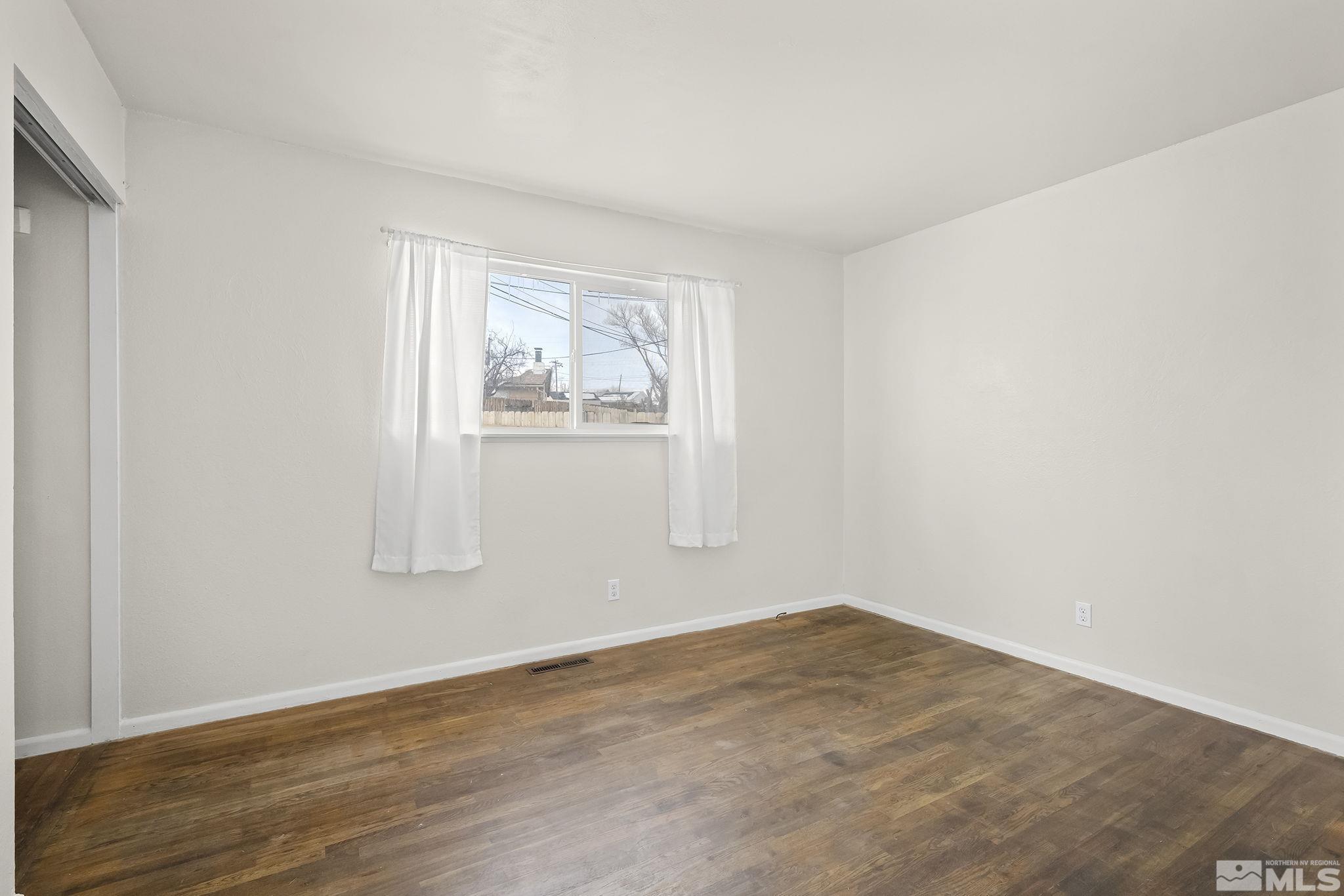 3475 Rauscher Drive Reno, NV 89503 - Photo 11 of 16 an empty room with wooden floor and window