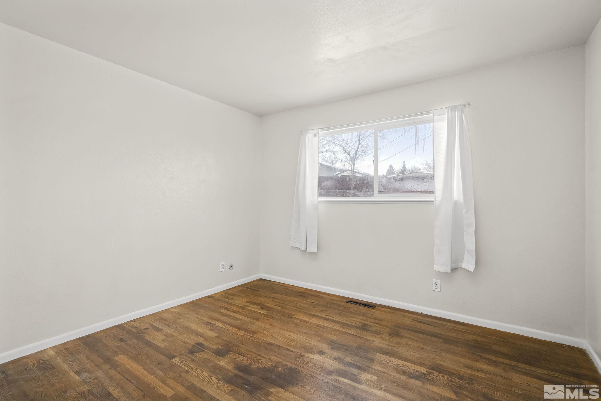 3475 Rauscher Drive Reno, NV 89503 - Photo 9 of 16 an empty room with wooden floor and windows