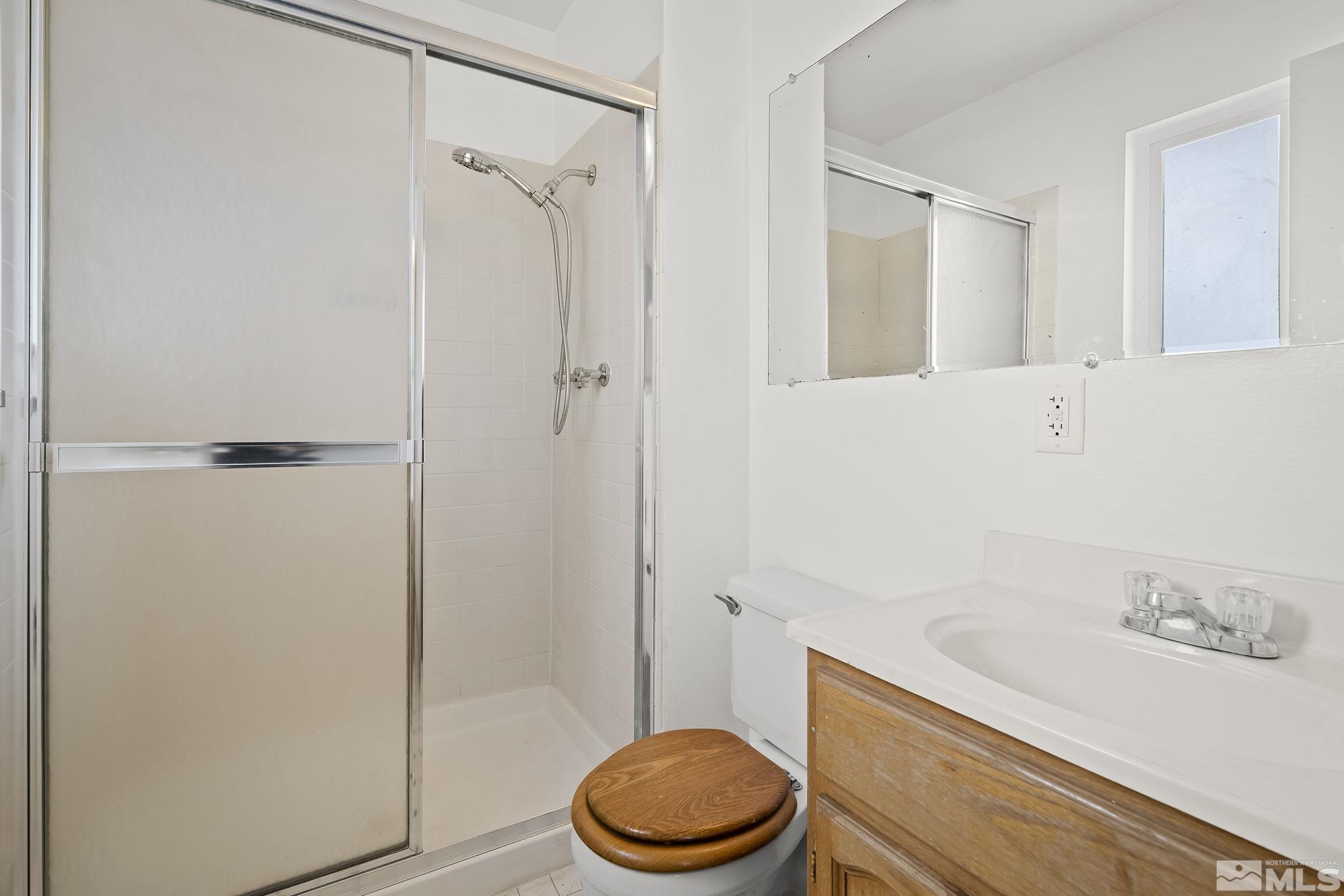 3475 Rauscher Drive Reno, NV 89503 - Photo 10 of 16 a bathroom with a granite countertop toilet and a sink