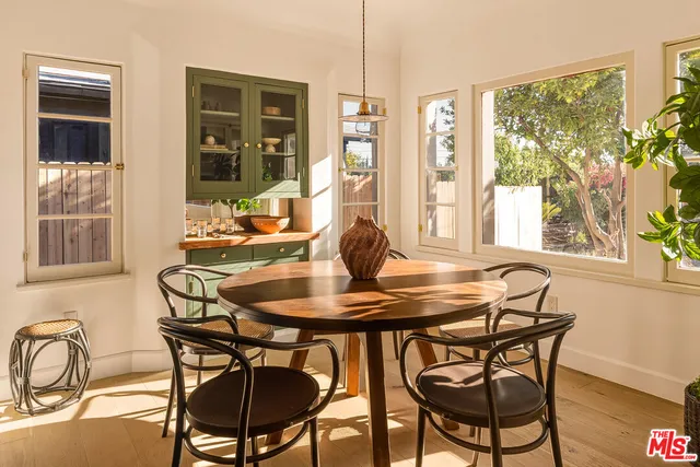 a dining room with furniture a chandelier and wooden floor